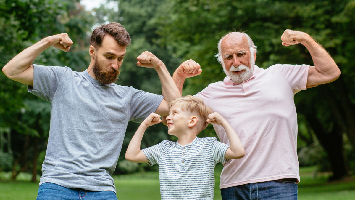 3 generations of smiling males showing their bicep muscles